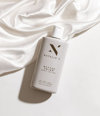 Better Aging body lotion lying on silk foulard