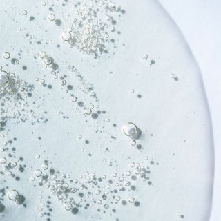 An enlarged drop of glycolic acid with air bubbles