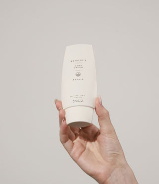 Repair hand cream held in hand